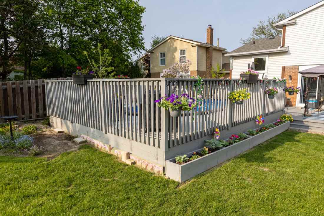 A newer Peachtree City back garden fenced on every boundary, with a pool enclosure inside it